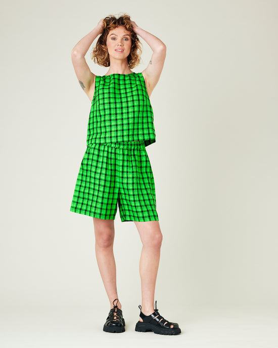model wears green and black check ari shorts