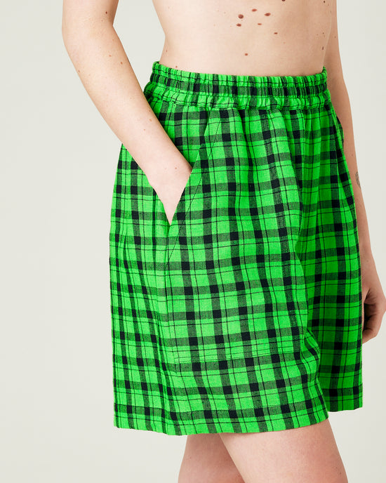 model wears green and black check ari shorts