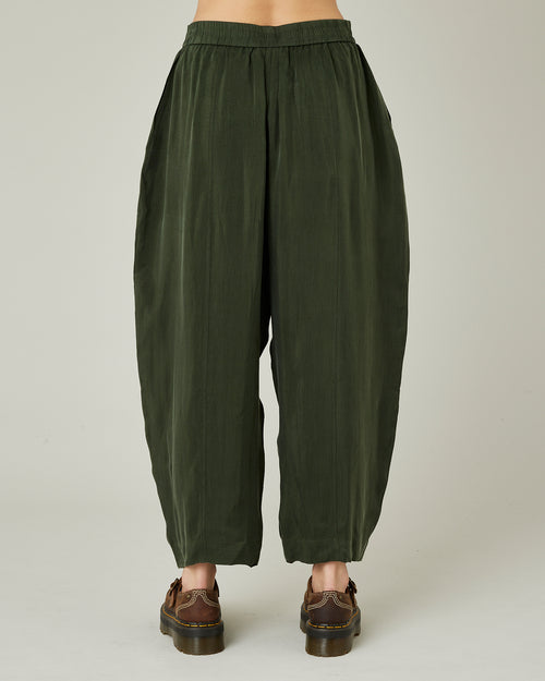 model wears dark khaki cupro mabel trousers