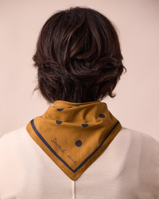 model wears toffee spotted neckerchief