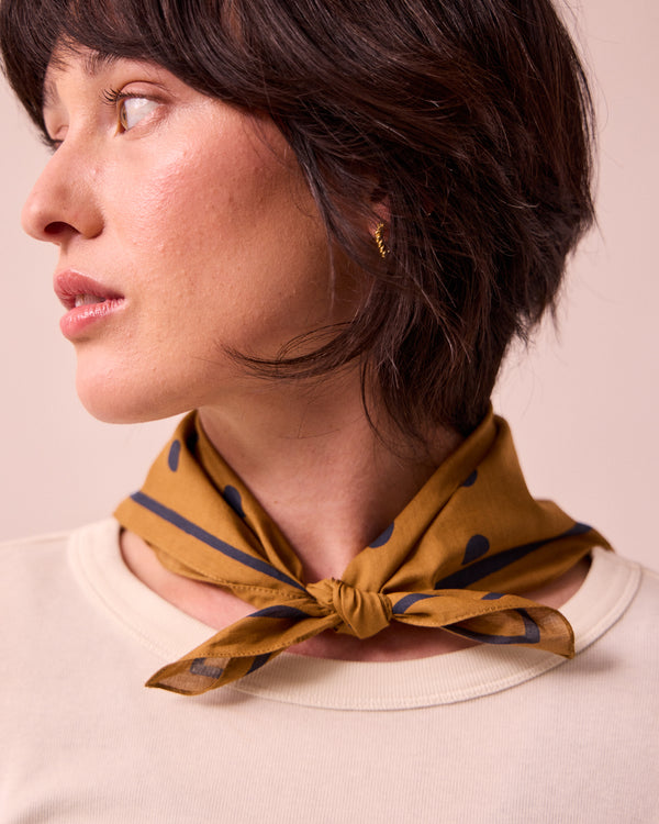 model wears toffee spotted neckerchief