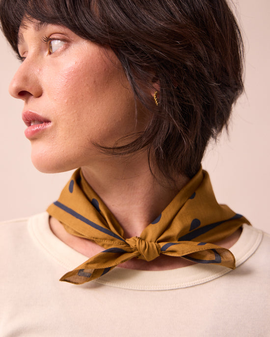 model wears toffee spotted neckerchief