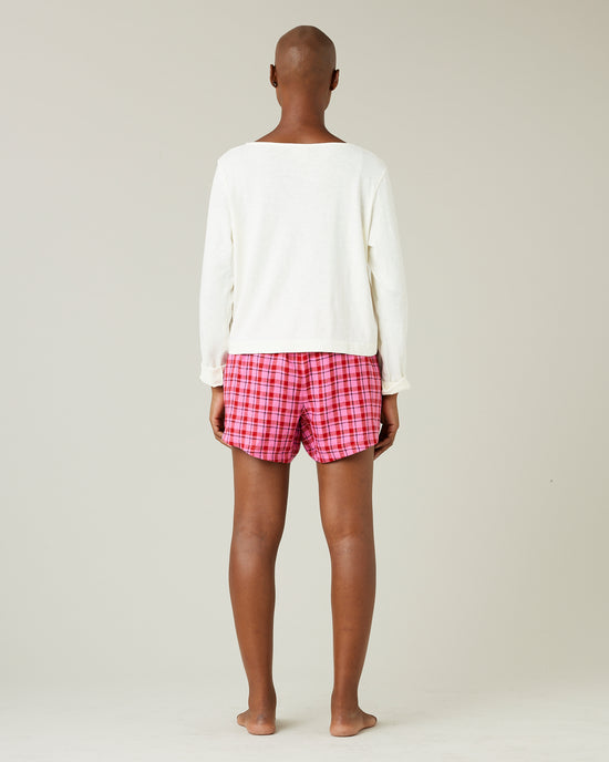 model wears pink and red check bed shorts