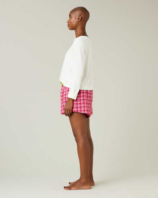 model wears pink and red check bed shorts