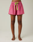 model wears pink and red check bed shorts