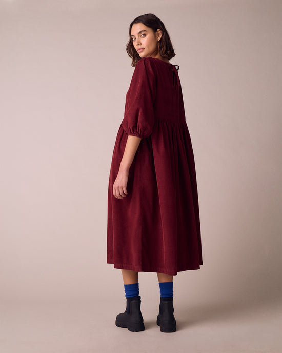 model wears berlin garnet cord dress