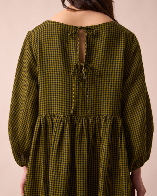 model wears berlin fresh olive mini gingham linen dress