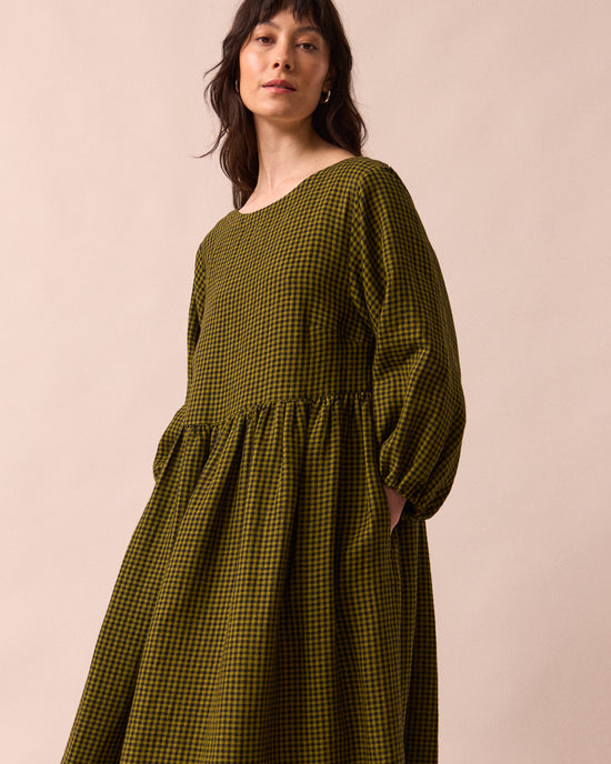 model wears berlin fresh olive mini gingham linen dress