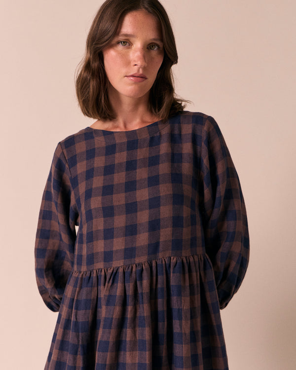 model wears berlin cedar check linen dress