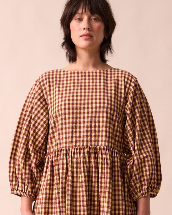 model wears berlin tan seersucker dress