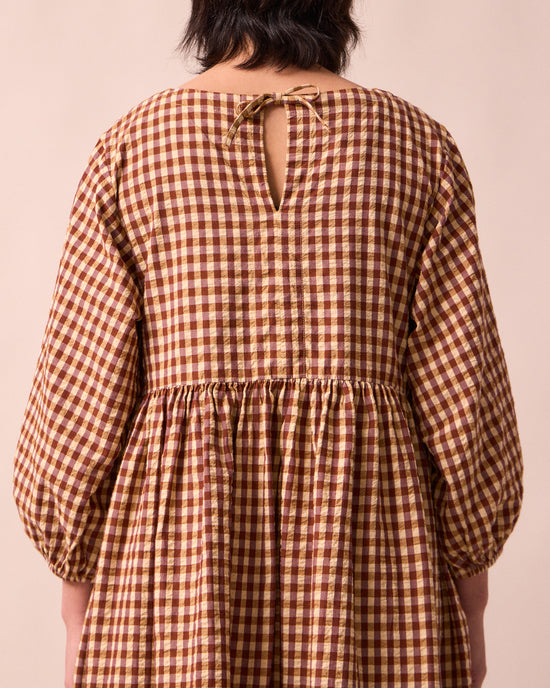 model wears berlin tan seersucker dress