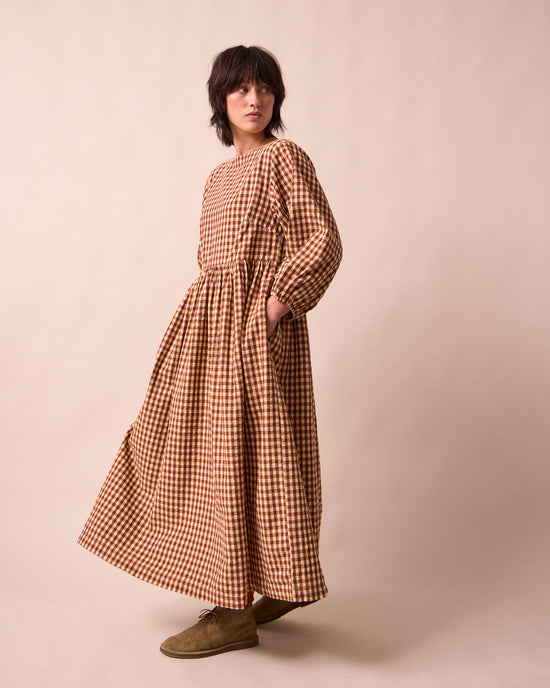 model wears berlin tan seersucker dress