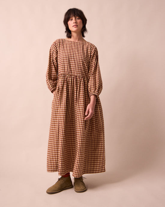 model wears berlin tan seersucker dress