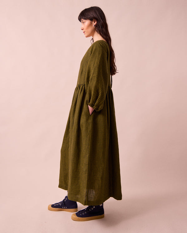 model wears berlin fresh olive mini gingham linen dress