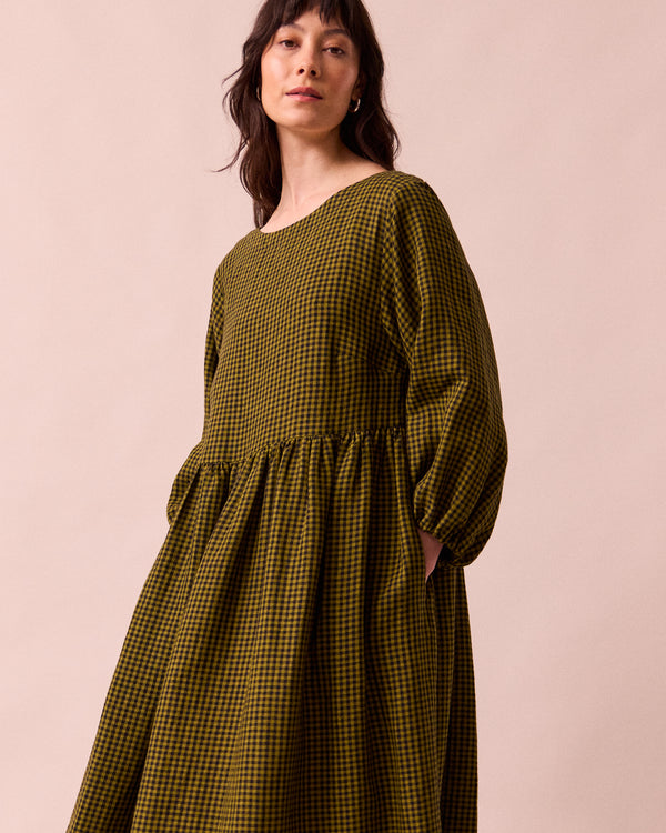 model wears berlin fresh olive mini gingham linen dress