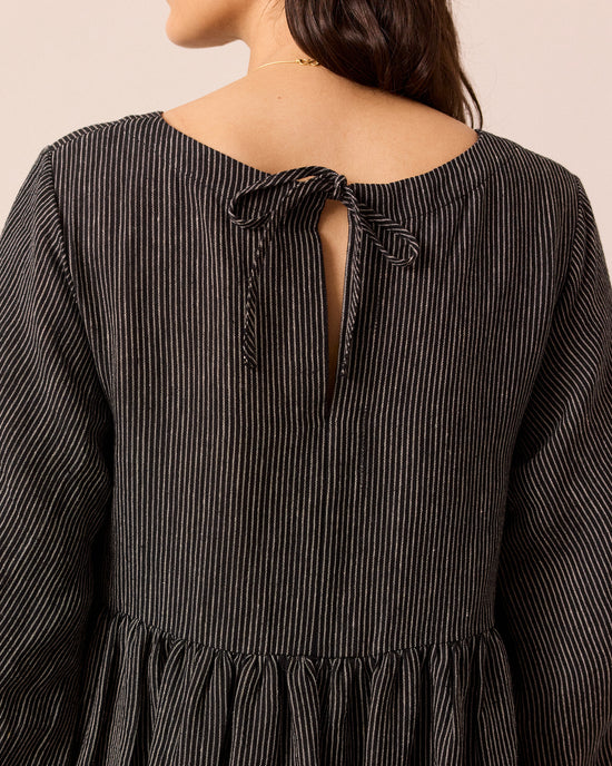 model wears berlin black and ecru pencil stripe linen dress