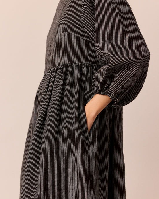 model wears berlin black and ecru pencil stripe linen dress