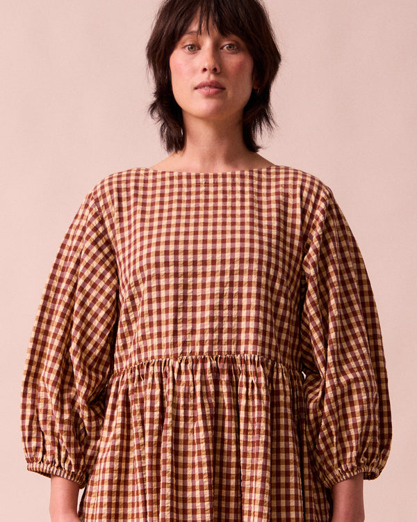 model wears berlin tan seersucker dress