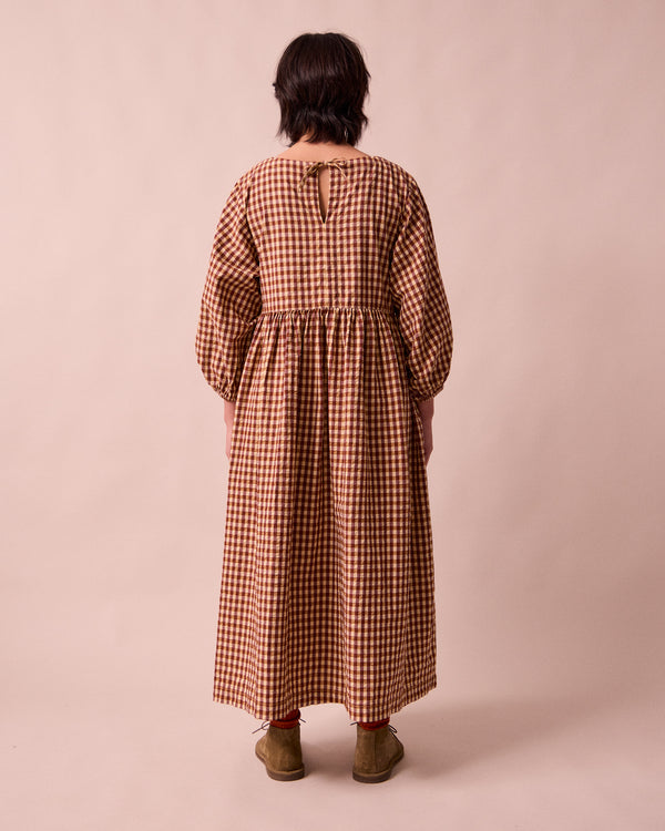 model wears berlin tan seersucker dress