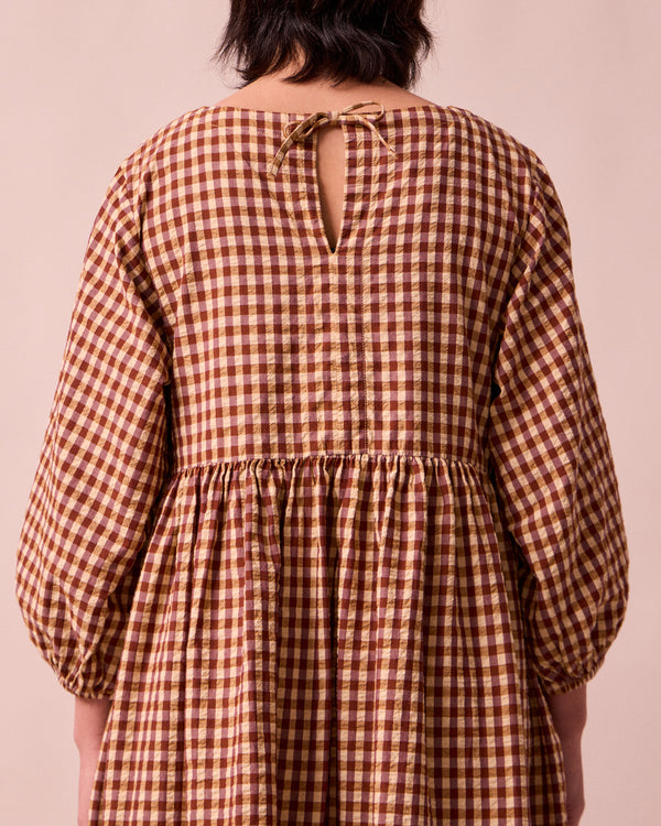 model wears berlin tan seersucker dress