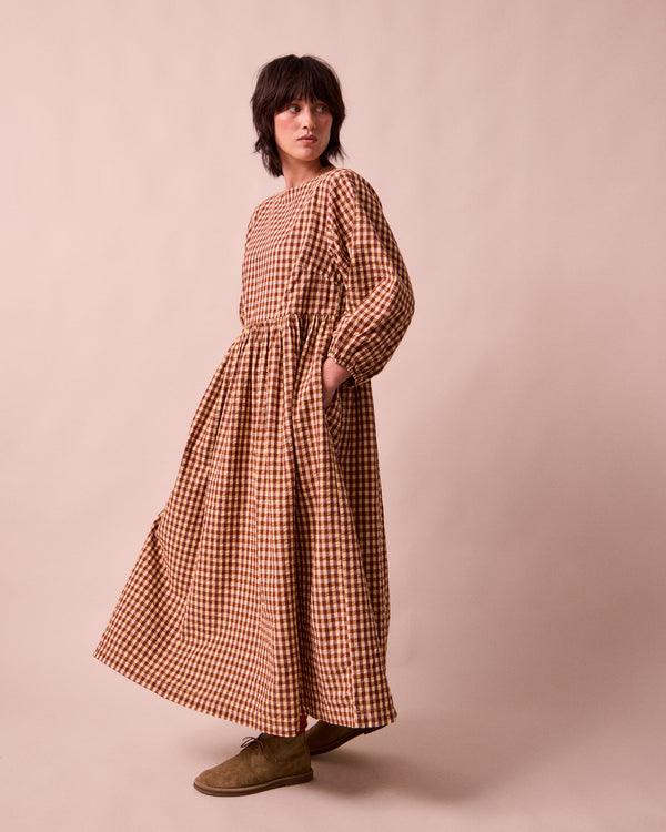 model wears berlin tan seersucker dress