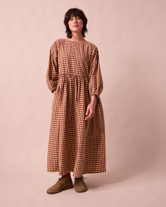 model wears berlin tan seersucker dress