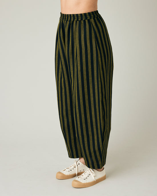 model wears black and olive stripe daisy trousers left