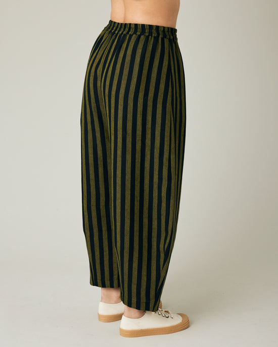 model wears black and olive stripe daisy trousers right