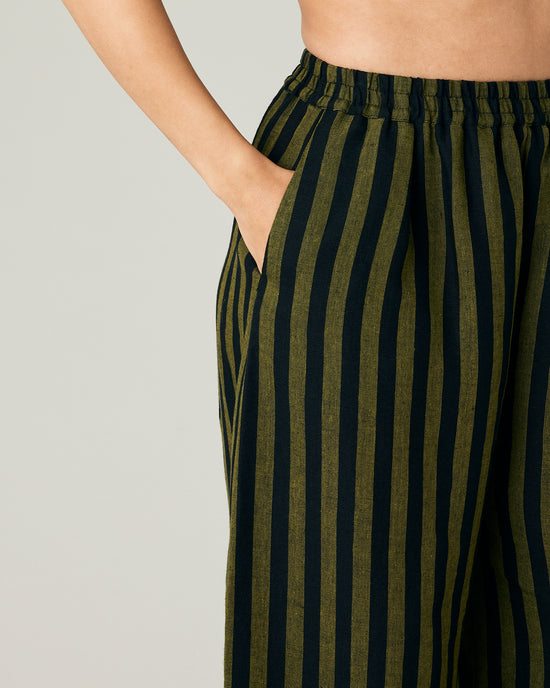 model wears black and olive stripe daisy trousers