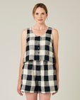 model wears stone and black mega check betty top