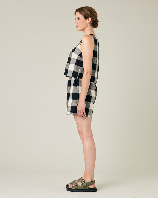 model wears stone and black check ari shorts