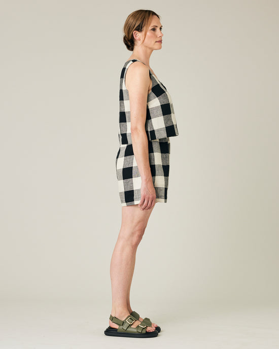 model wears stone and black check ari shorts