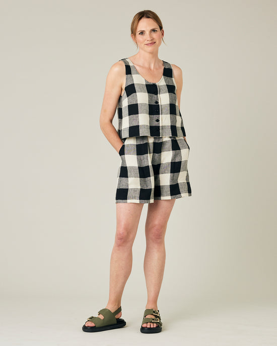 model wears stone and black mega check betty top