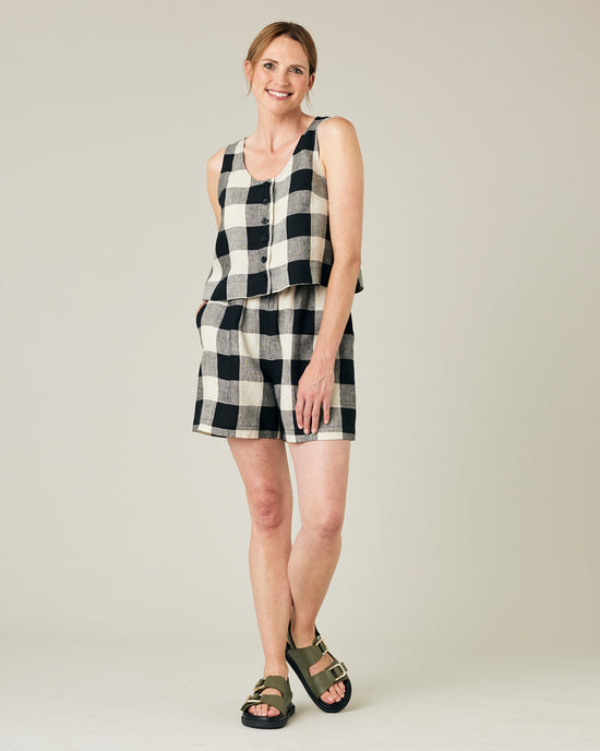 model wears stone and black mega check betty top