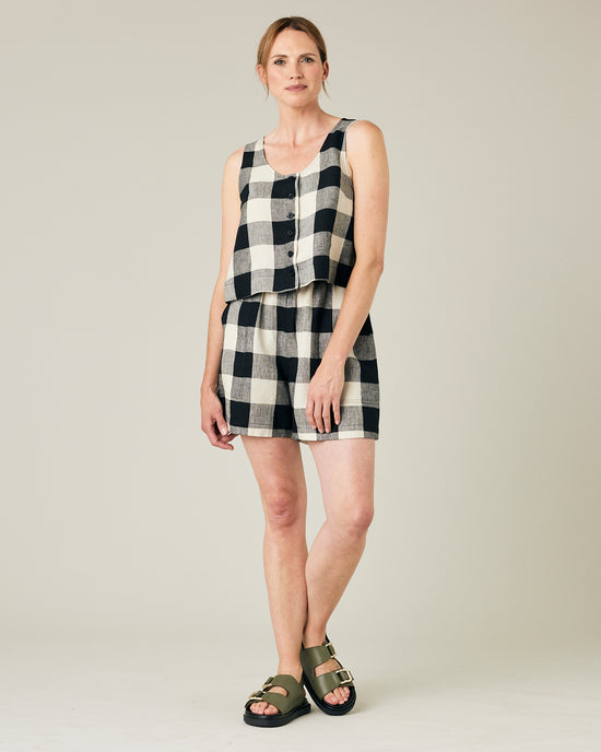 model wears stone and black check ari shorts