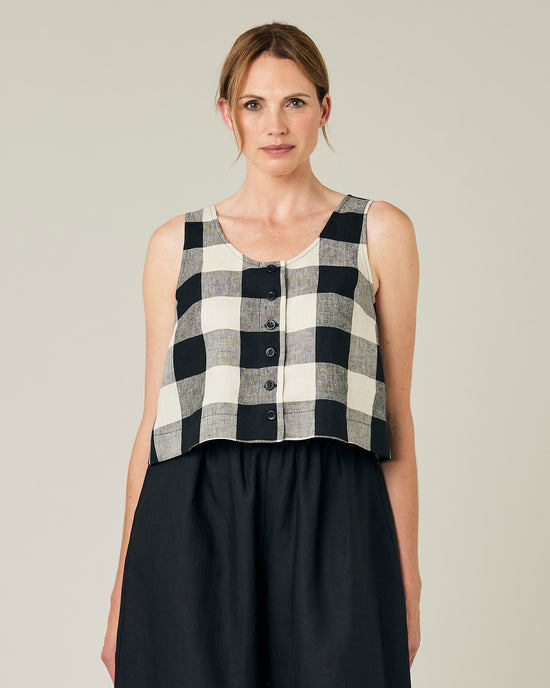 model wears stone and black mega check betty top