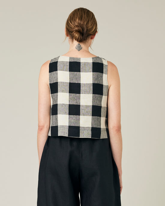 model wears stone and black mega check betty top