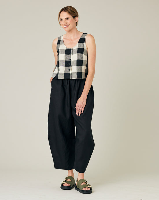 model wears stone and black mega check betty top