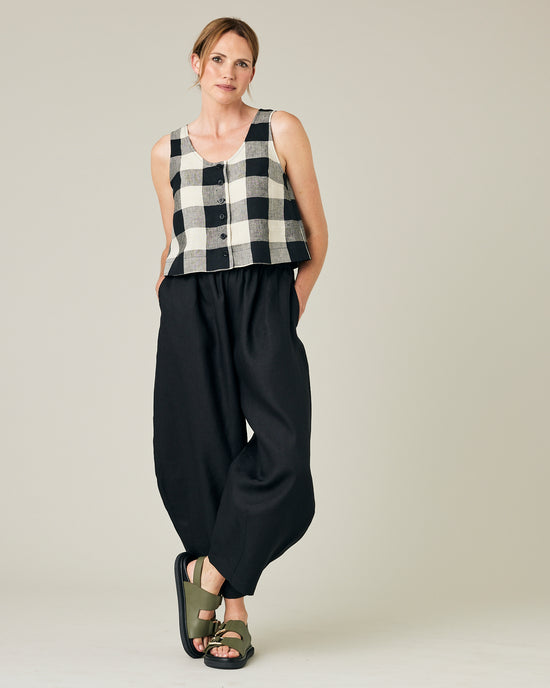 model wears stone and black mega check betty top