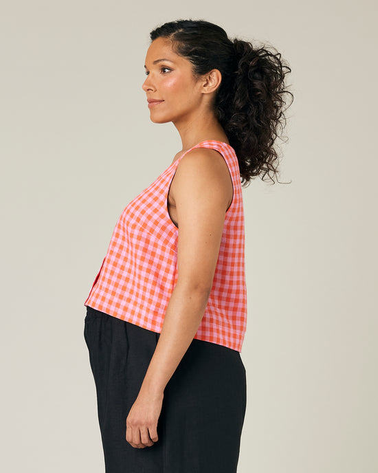 pregnant model wears pink and tomato check betty top