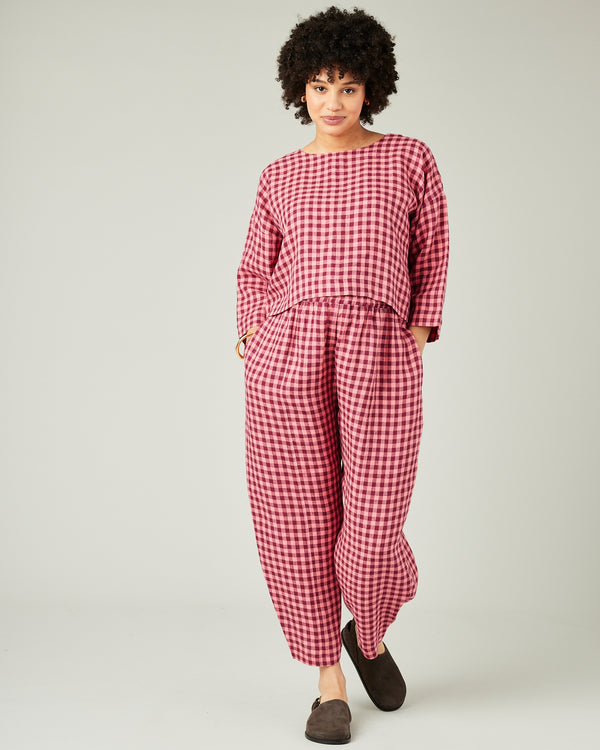 pregnant model wears blush gingham mabel linen trousers