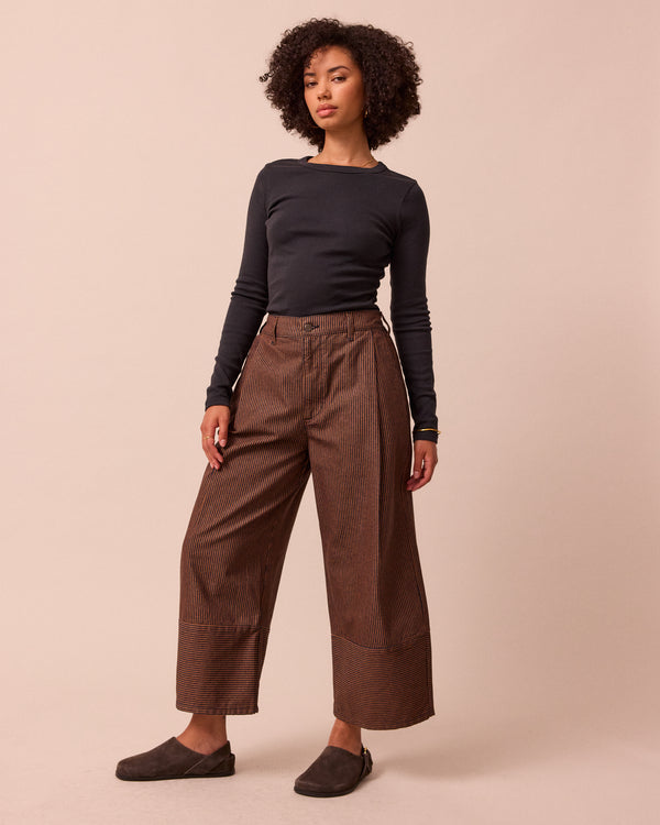 model wears blair hickory rust stripe denim jeans left