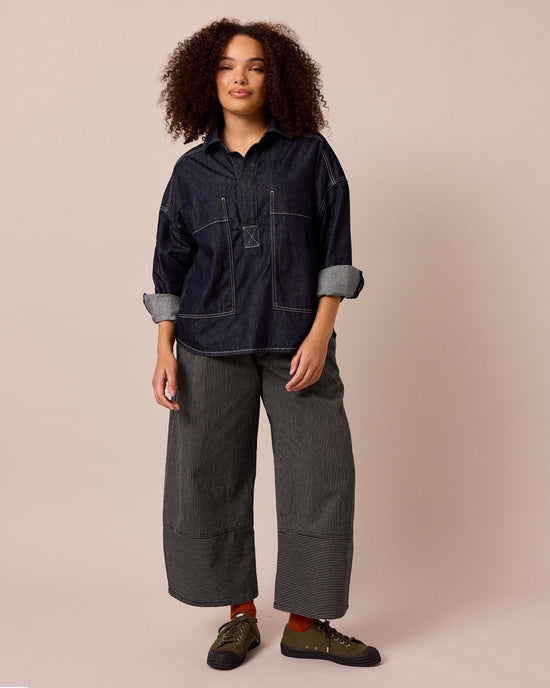 model wears blair black hickory stripe denim jeans left