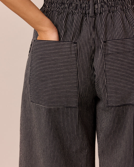 model wears blair black hickory stripe denim jeans