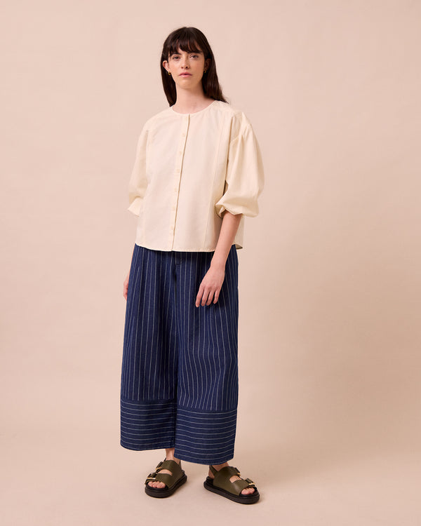 model wears blair mid blue pinstripe denim jeans left