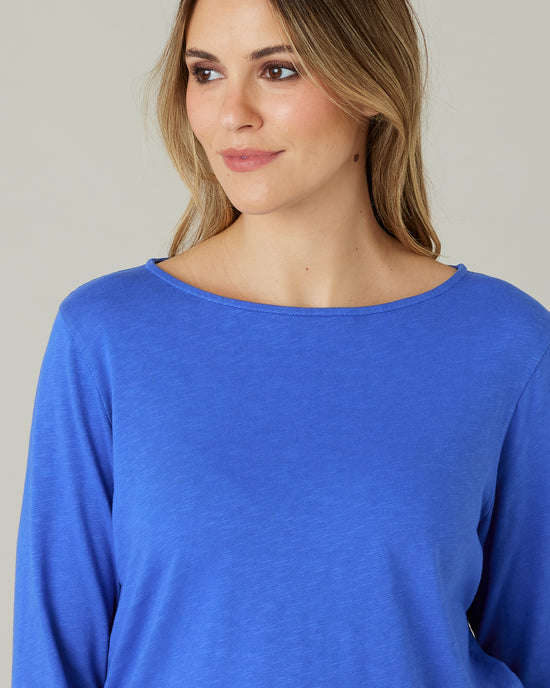 pregnant model wears lapis blue boat neck top