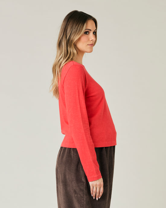 pregnant model wears red boat neck top