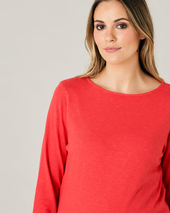 pregnant model wears red boat neck top