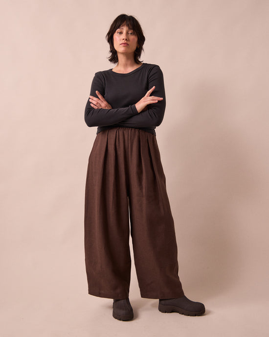 model wears bobbi chocolate linen trousers left