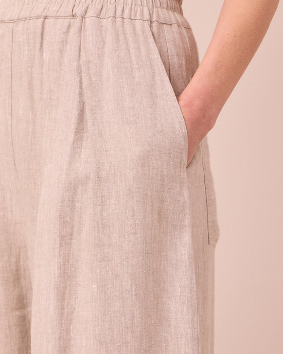model wears bobbi natural linen trousers 